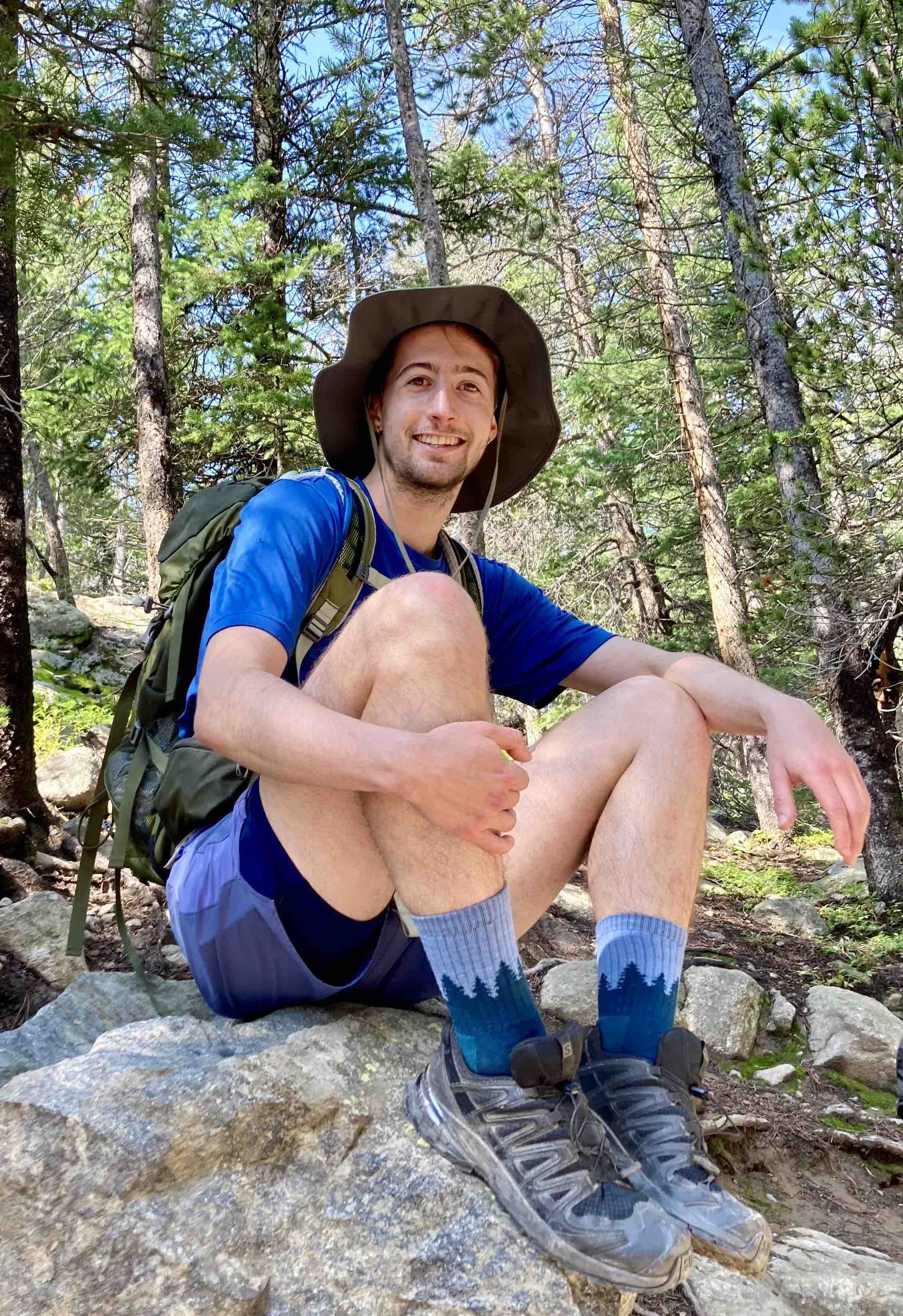 Will sitting on a rock in a forest